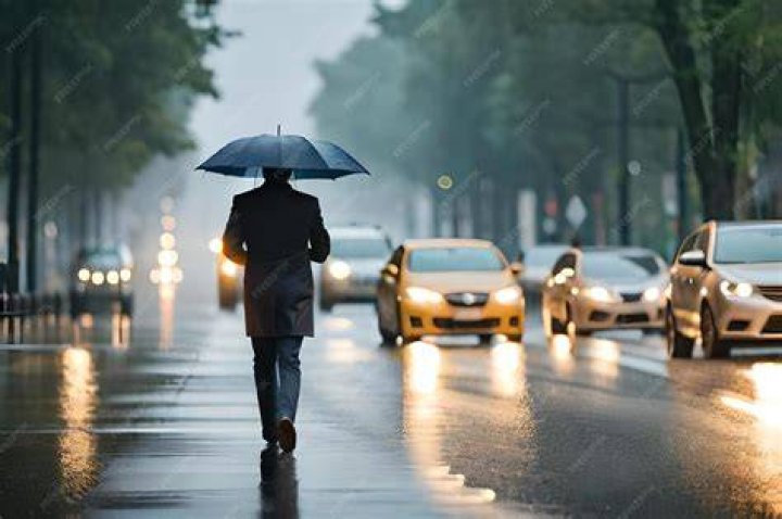 A man walks with umbrella on Rodeo Drive in Beverly Hills, as atmospheric river storms hit Los Angeles, California