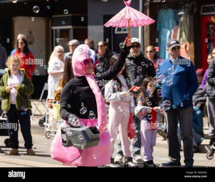A reveller dressed as a horse parades in front of large crowds which gather every year to watch the spectacle