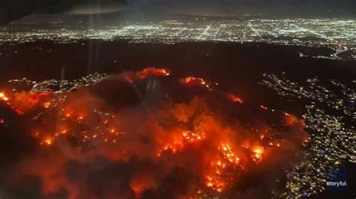 Aerial view showing a fire truck driving through destruction caused by the wildfire in Lahaina, Maui, Hawaii