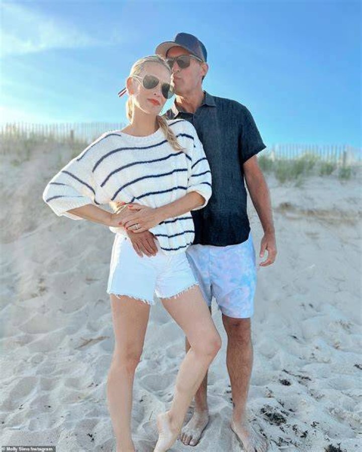 Beach babes! Scott appeared to be puckering up to his wife