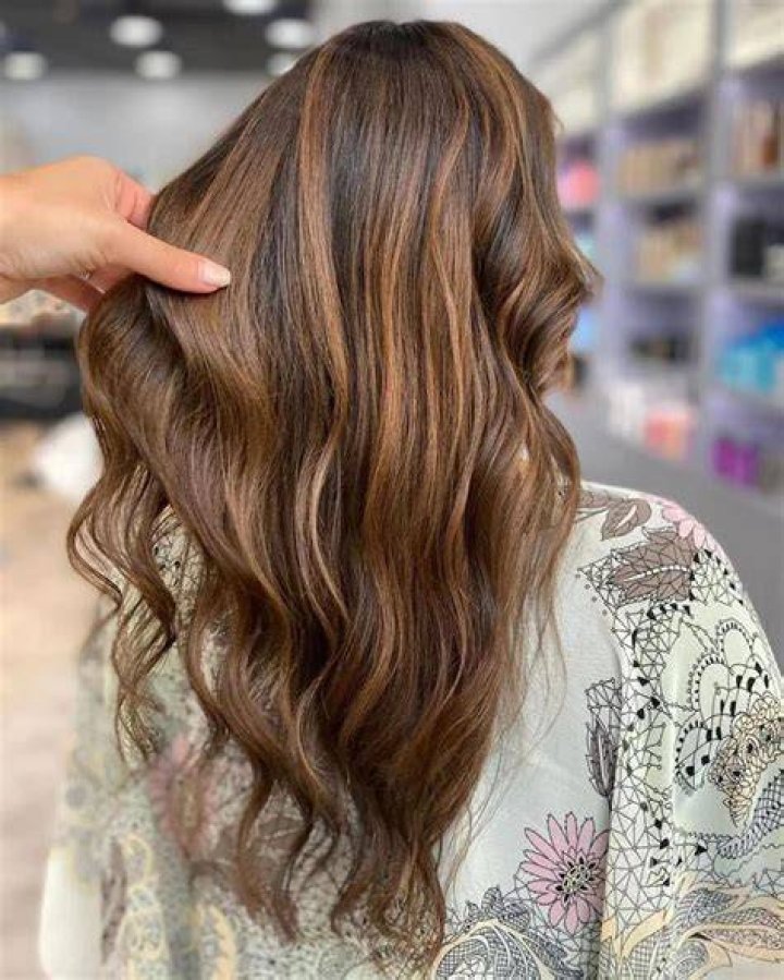 Hair Expert Nicole Petty at Milk + Blush said: 'While one-length hair can look chic on some people, it can be tricky to pull off and can end up ageing you. To add volume and movement to thinning hair, ask your hair stylist to add feathery, subtle layers throughout your hair and a few face-framing layers (pictured)'