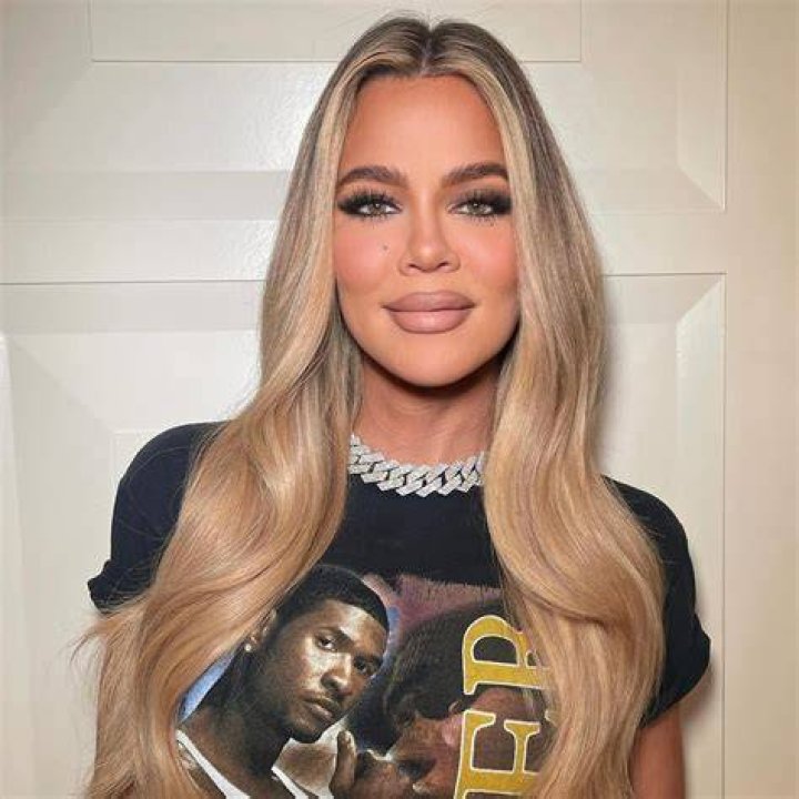 Khloe splashed around in style, wearing a matching animal print scarf over her long, blonde locks