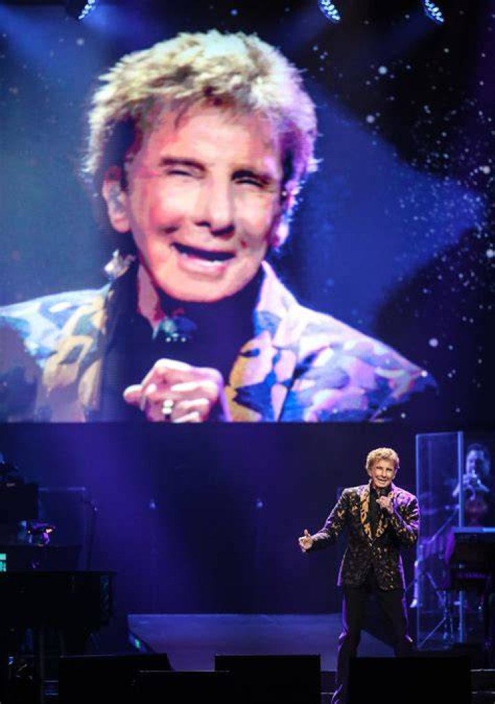 Legendary singer-songwriter Barry Manilow (pictured here performing last week) has been ordered not to speak, sing or rap for 48 ours after he was rushed to a Los Angeles hospital on Wednesday following complications from emergency oral surgery he had earlier this week