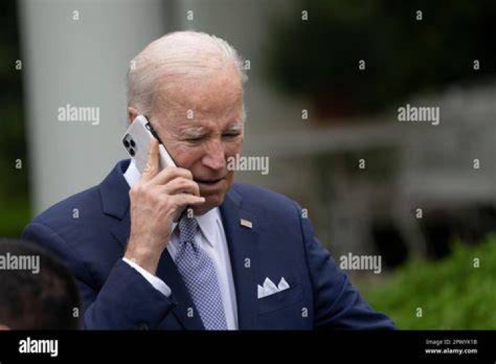 Morales takes a phone call as her husband Joe Rhodes walks ahead of her during their stroll on Friday