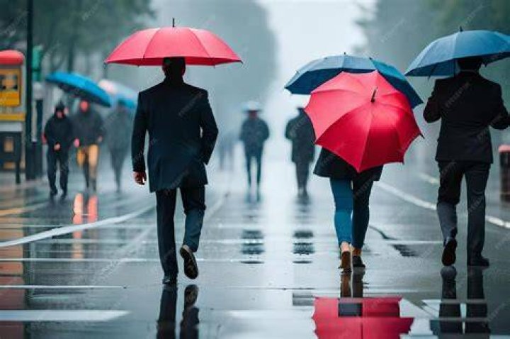 People walk with umbrellas on Rodeo Drive in Beverly Hills, as atmospheric river storms hit Los Angeles, California
