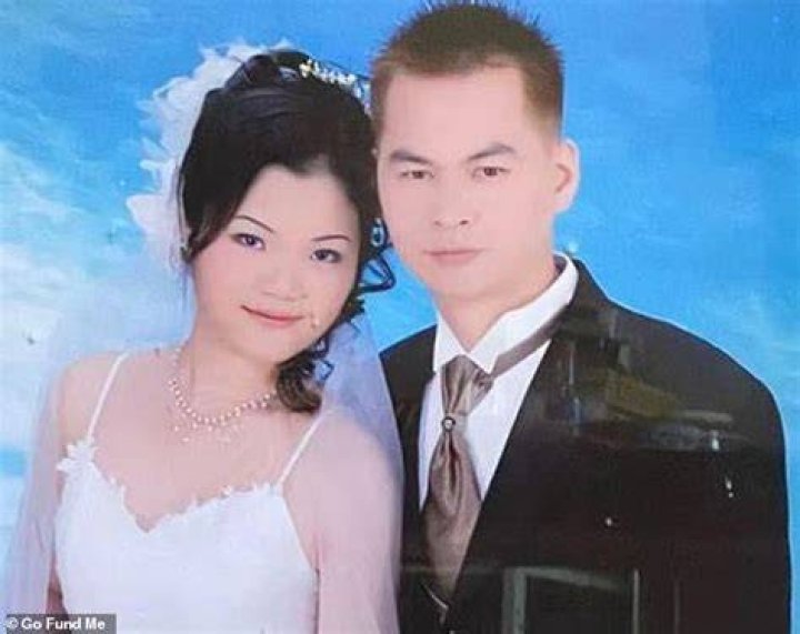 Zhiwen Yan, 45, pictured with his wife in what appears to be a wedding photo. Yan, who worked as a Chinese food delivery man, 45, was shot dead in New York City: The shooter was a disgruntled customer who had 'multiple' disputes with the restaurant over his orders and twice threatened workers with a gun